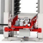 Nahaufnahme einer industriellen Maschine mit roten und weißen Komponenten, wahrscheinlich Teil eines automatisierten Förder- oder Handhabungssystems.